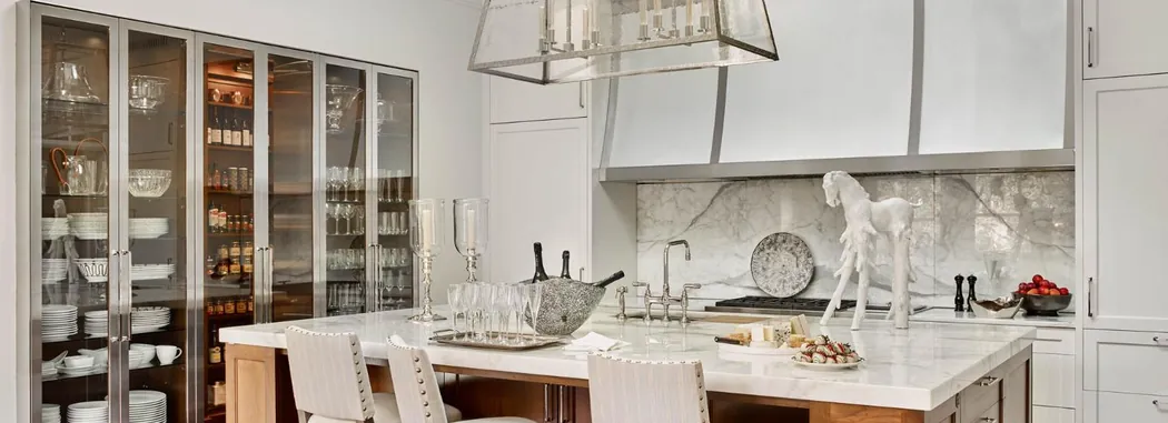 Butler's pantry and bar with glass-front cabinetry, marble backsplash and polished nickel fittings